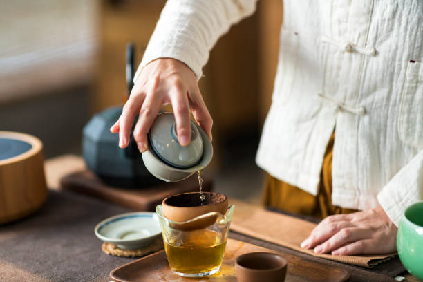 Woman serving Chinese tea in a tea ceremony.